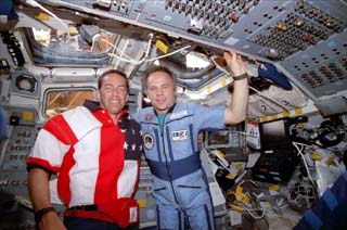 STS-86 commander James Wetherbee (left) and Mir-24 commander Anatoly Solovyev on the Atlantis's aft flight deck, under the overhead windows.